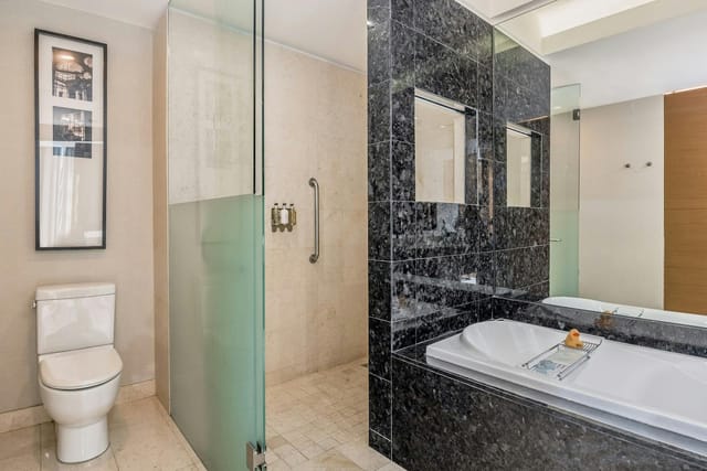 Accessible hotel bathroom with stone shower at Live Aqua CDMX, perfect for luxury event lodging.