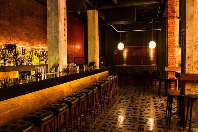 Industrial-chic jazz club with exposed brick, ideal for VIP networking and cocktail events.
