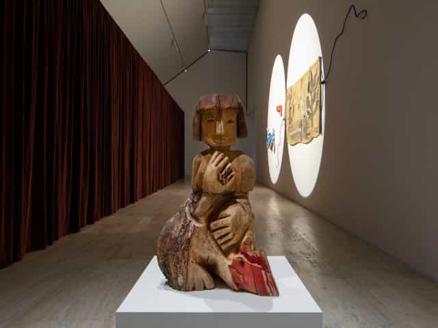 High-end gallery space with dramatic lighting for intimate cocktail reception and art events.