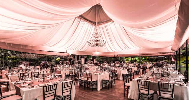 Luxury banquet hall marquee with chandelier, perfect for elegant wedding and corporate events.