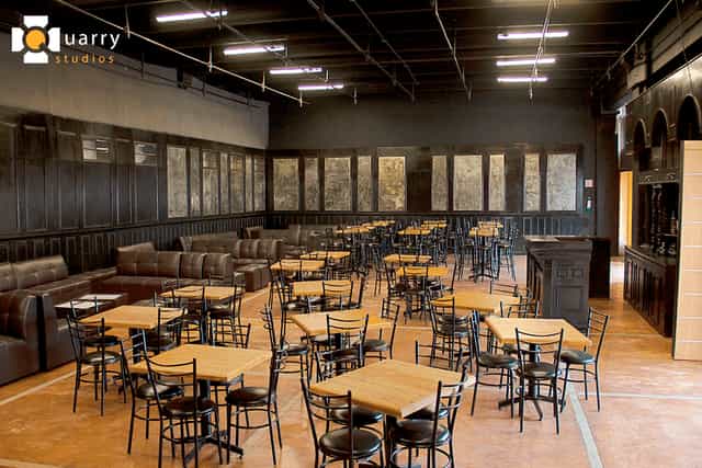 Industrial-chic Bar at Quarry Studios with modular seating for networking mixers and events.