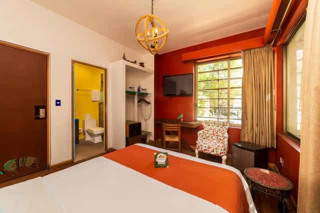 Budget-friendly Casa Anzures guest room with eclectic decor for solo travel and conferences.