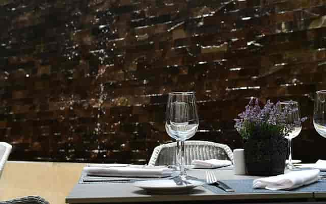 Sophisticated al fresco corporate luncheon at Restaurante Aktuel with elegant floral table settings.