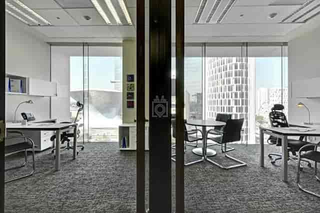 Modern executive office with meeting table, perfect for corporate meetings and workspace rentals.