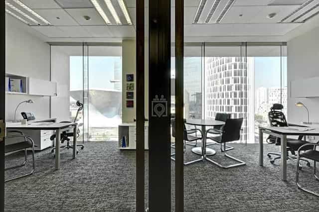 Modern executive office with meeting table, perfect for corporate meetings and workspace rentals.