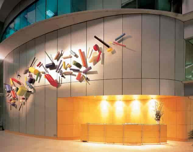 Modern reception desk at Siglum Tower with abstract wall for event registration and branding.