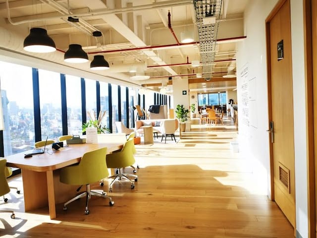 Modern coworking breakout space with lounge seating for professional networking and meetings.