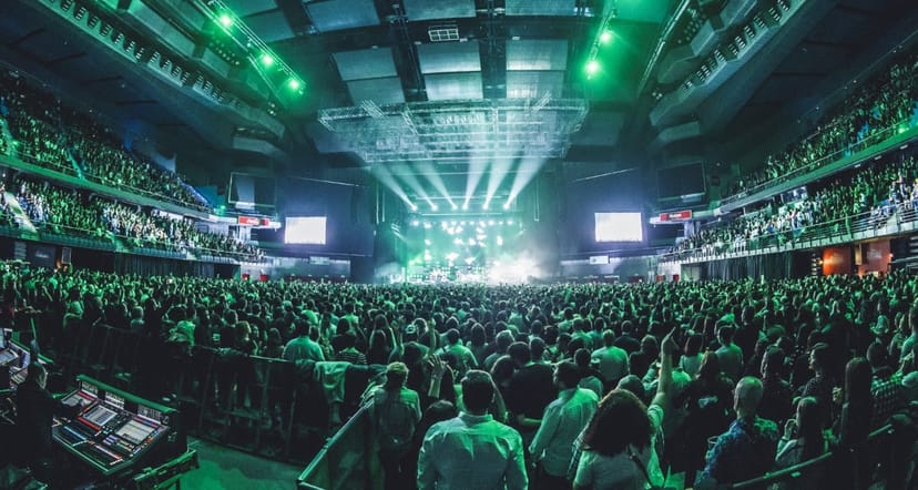 Full-capacity Pepsi Center concert hall with stadium seating for corporate event and conference.