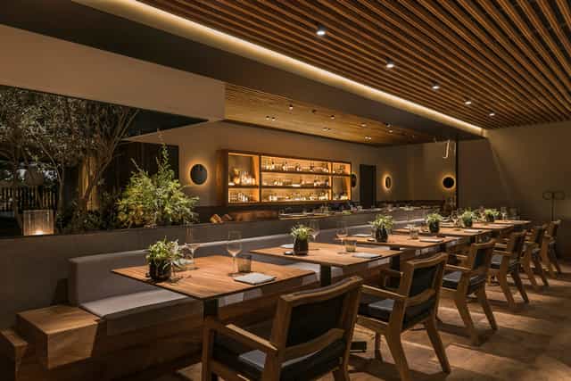 Pujol restaurant with warm decor for intimate corporate dinners and private networking events.