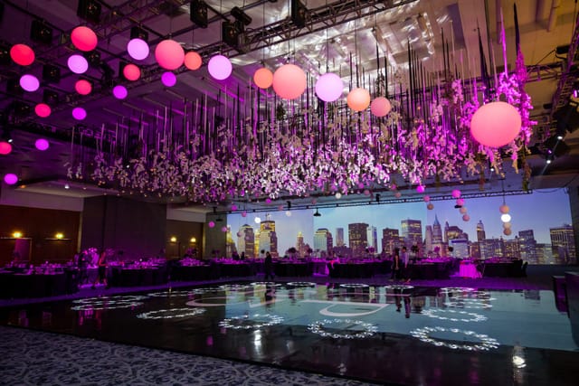 Gala at Centro Banamex featuring custom dance floor, floral installations, and LED event backdrop.