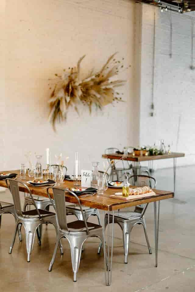 Rustic-industrial event dining with wood tables at SKYLIGHT for intimate wedding or corporate gala.