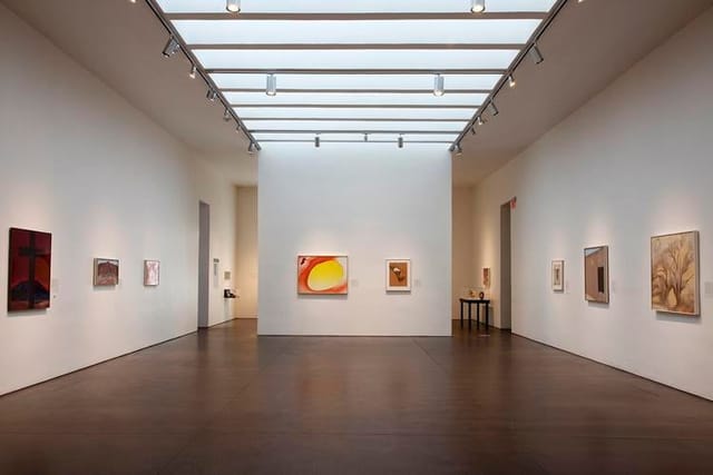 Minimalist Georgia O'Keeffe Museum gallery with skylight for product launches and networking events.