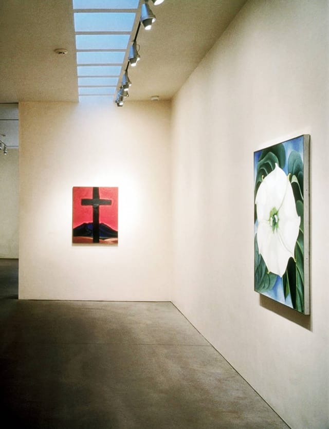 Minimalist Georgia O'Keeffe Museum gallery with spotlights for corporate event or art exhibition.
