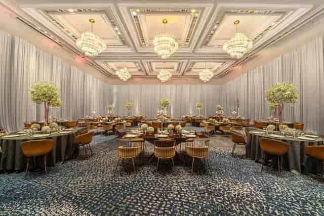 Elegant ballroom with tiered chandeliers for corporate gala or upscale wedding venue.