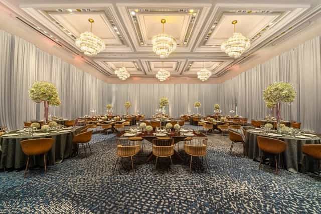 Elegant ballroom with tiered chandeliers for corporate gala or upscale wedding venue.