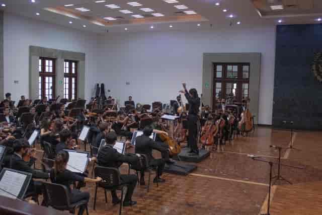 Orchestra performing in Auditorio C, Los Pinos: versatile cultural event and music venue.