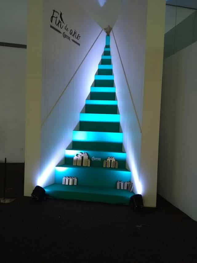 Banquetes Mayita hall with vibrant LED uplighting for immersive corporate event and gala branding.