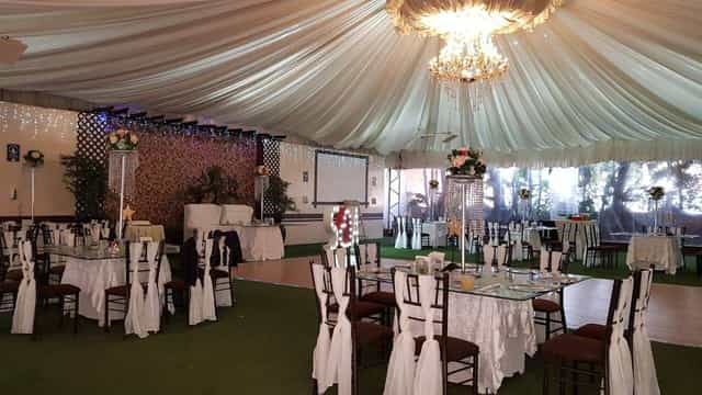 Salón Jardín event venue with elegant ceiling draping for formal banquets and wedding receptions.