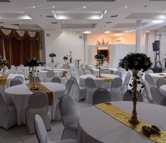 Le Crillon banquet hall with gold-accented round tables for formal events and wedding receptions.