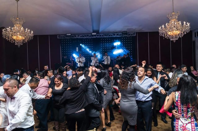 Live band performing at a high-energy gala event on a packed dance floor at Terraza Le Crillon.