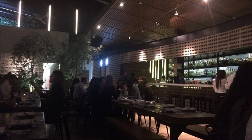 Sophisticated rooftop bar with communal seating for corporate networking events.