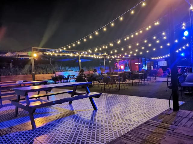 Antisocial Rooftop evening mixer venue with string lighting for networking events.