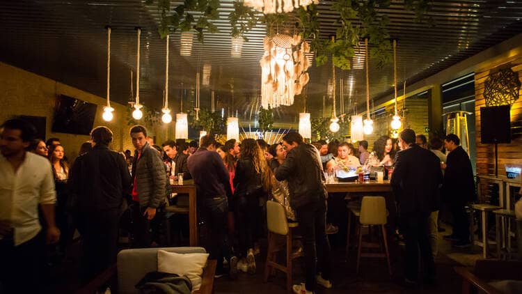 Networking mixer at Alchemist Rooftop with communal seating for corporate social events.