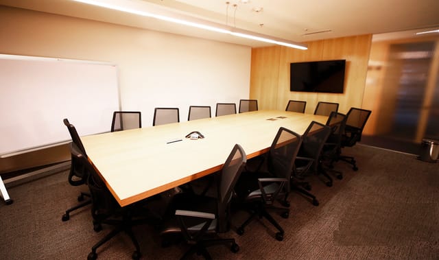 Modern boardroom at WRK with minimalist design, ideal for corporate meetings and workshops.