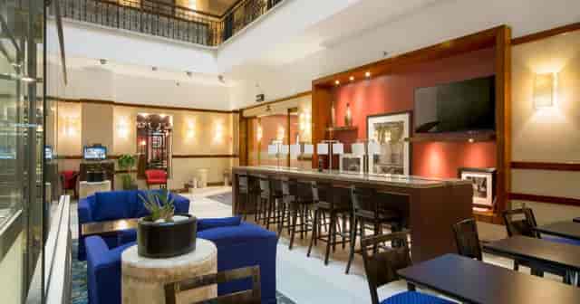 Hampton Inn Mexico City hotel lobby with communal workspace for professional business events.