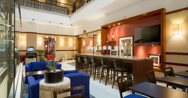Hampton Inn Mexico City hotel lobby with communal workspace for professional business events.