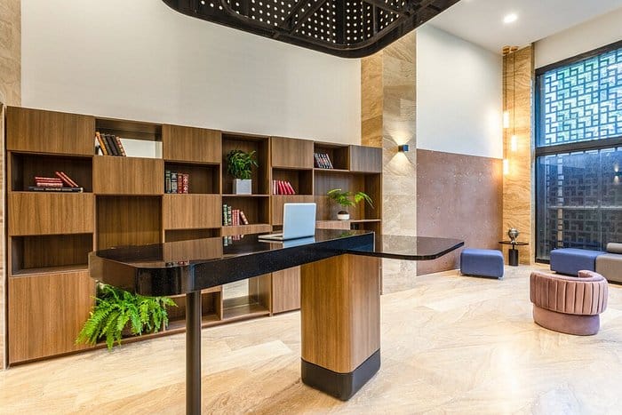Modern hotel coworking space with high-top workstation for business meetings and hotel events.