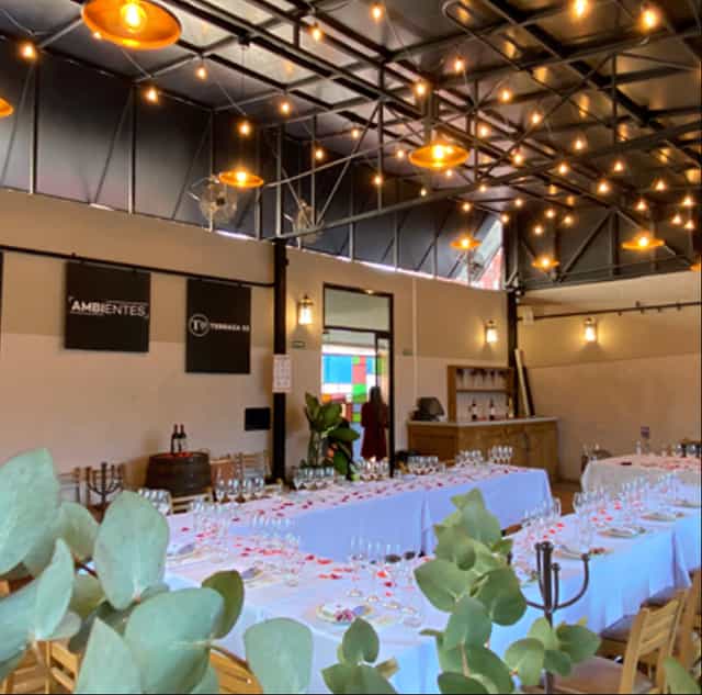 Industrial-chic event venue with ambient lighting for weddings and corporate mixers.