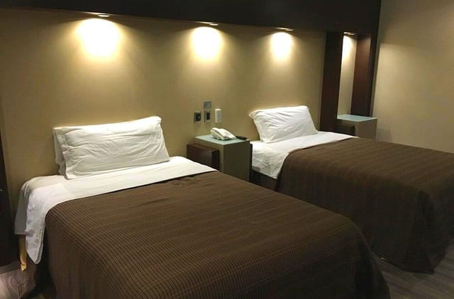 Double-occupancy hotel room for budget conference delegates and event accommodation.