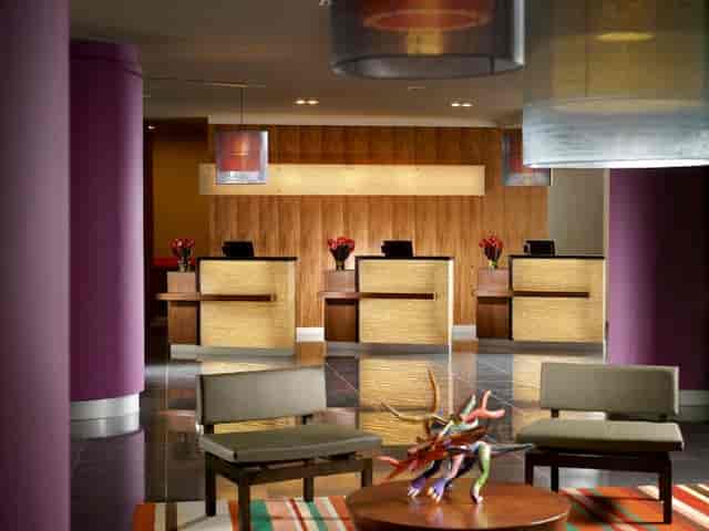 Modern hotel reception desk at Courtyard Mexico City Airport for group check-in and event logistics.