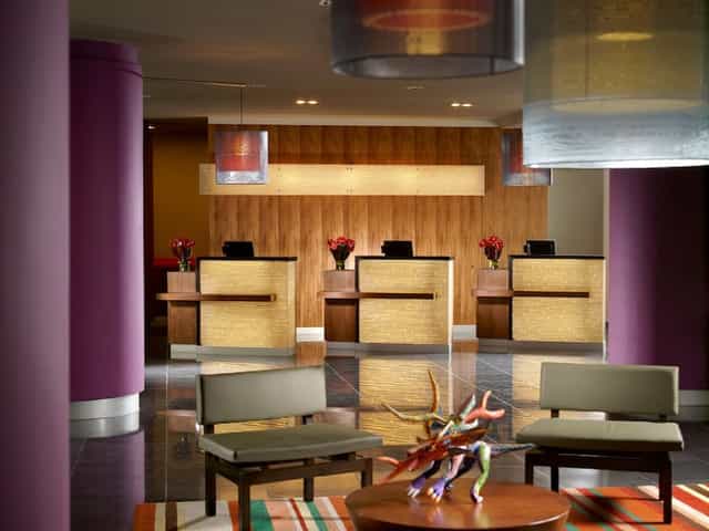 Modern hotel reception desk at Courtyard Mexico City Airport for group check-in and event logistics.