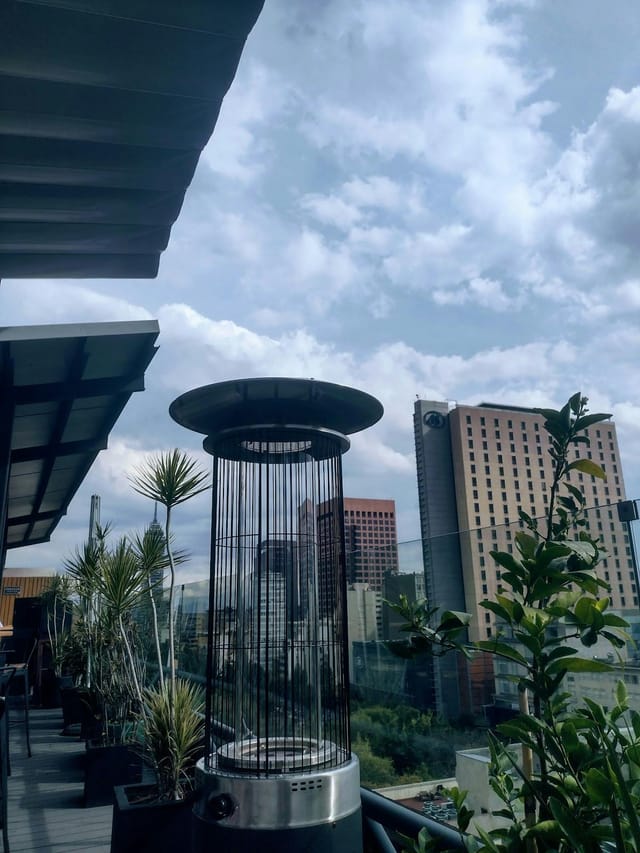 XKINA Rooftop corporate evening reception with city skyline views and climate control.