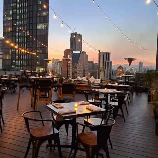 XKINA Rooftop venue with string lighting for corporate mixer and networking event.