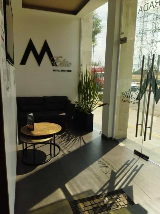 Compact boutique hotel lobby for pre-conference meetings and business event networking.