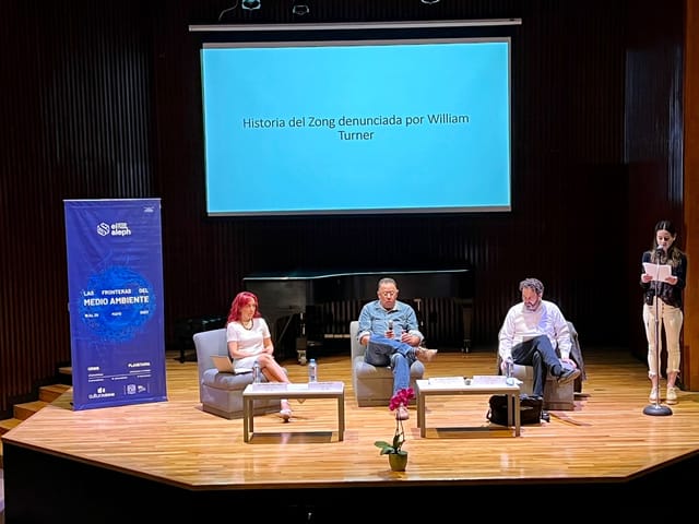 Panel discussion on stage at Sala Carlos Chávez, UNAM for professional lecture or seminar.