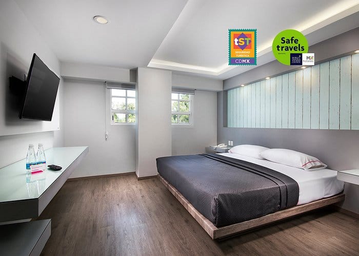 Modern hotel suite with minimalist desk for business travel in Mexico City.
