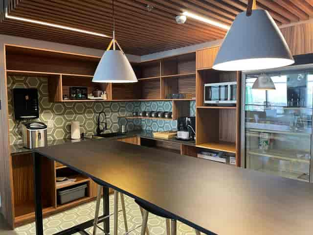 Modern breakout kitchenette in Workology for casual networking and off-site meetings.