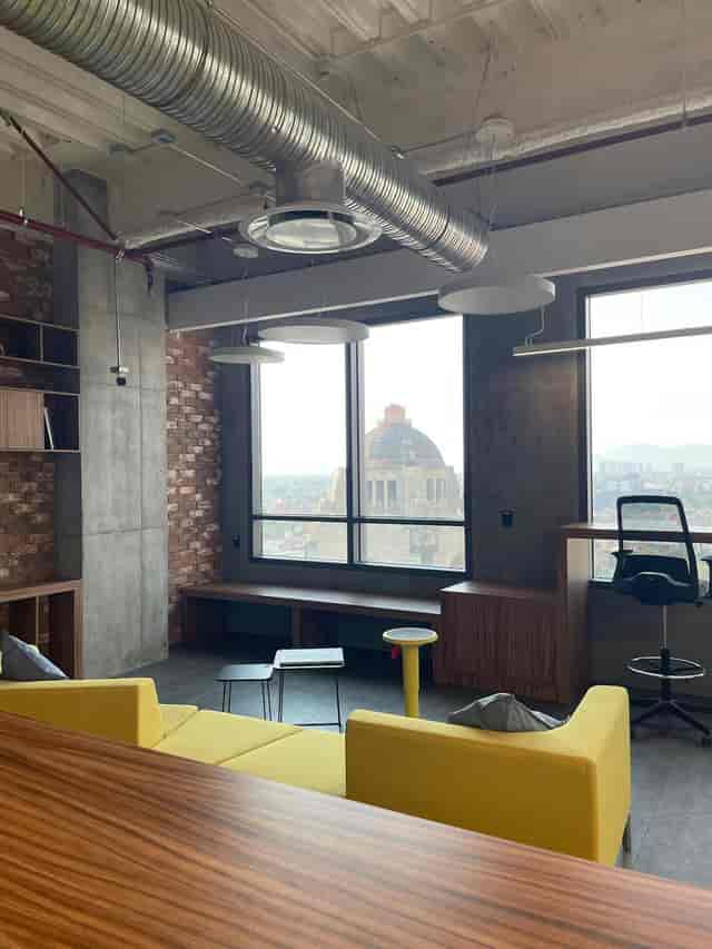 Industrial-chic breakout room with landmark views for creative corporate meetings.