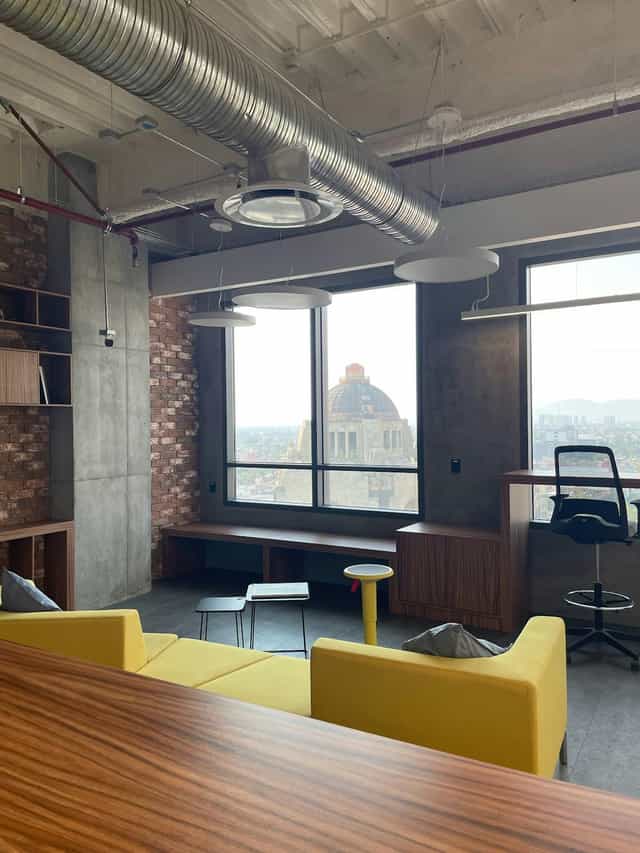 Industrial-chic breakout room with landmark views for creative corporate meetings.