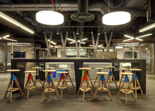 Modern Torre AXA meeting room with high-top tables for networking and brainstorming events.