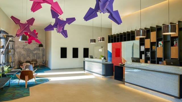 Modern hotel lobby with dual-desk registration for corporate events and group check-ins.
