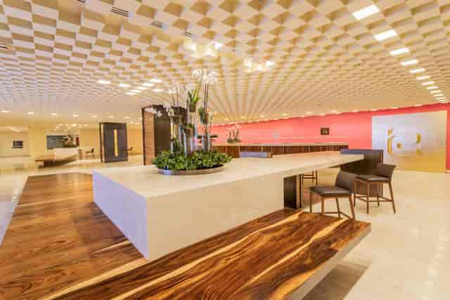 Modern foyer with geometric ceiling for high-end corporate events and premium registration desks.