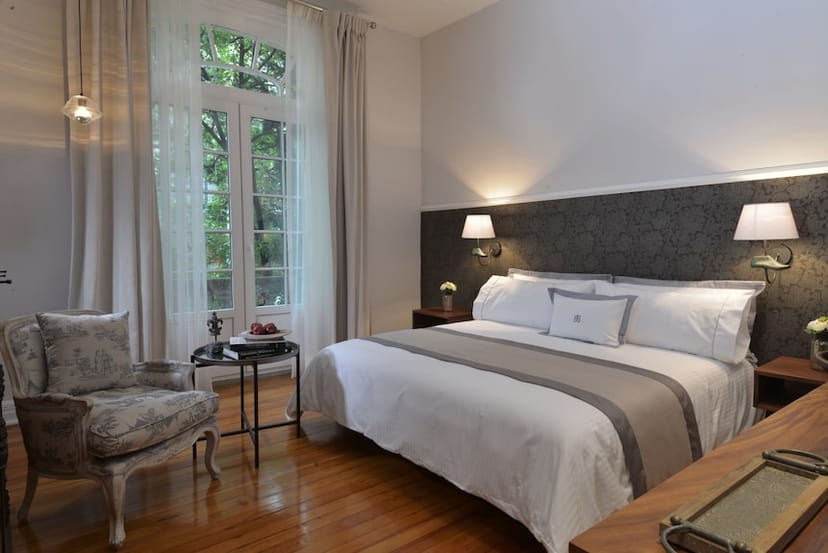 Luxury executive guest room at Casa Goliana with seating nook for business travel.
