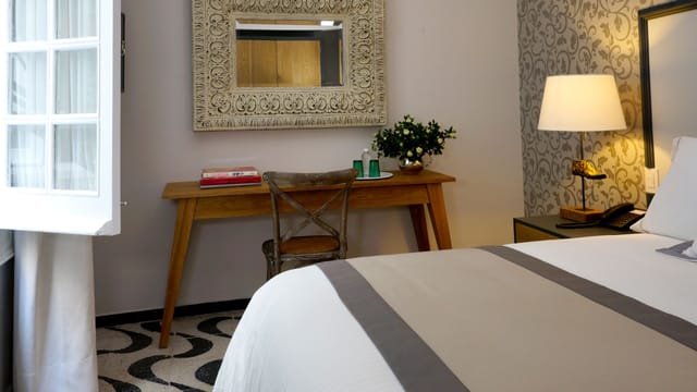 Boutique hotel guestroom with workspace at Casa Goliana, ideal for business travel and remote work.