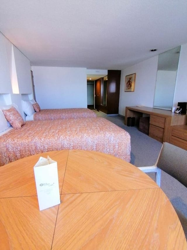 Carranza Room hotel double-occupancy, functional workspace, budget event lodging, business travel.