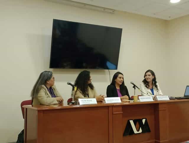 Four-person panel discussion at Casa Rafael Galván, professional conference event setup.